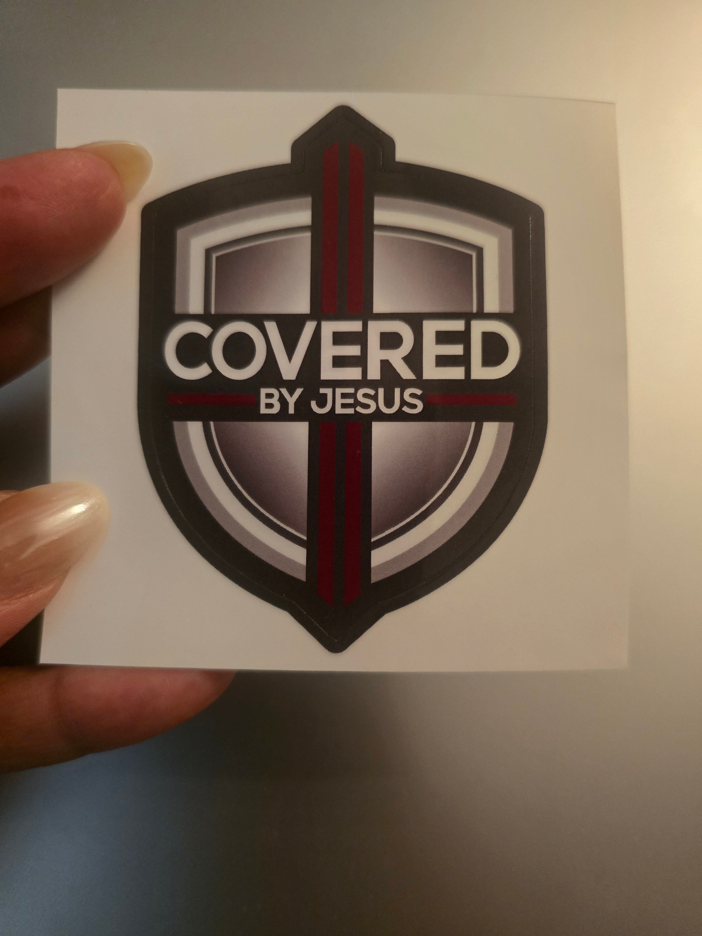 Covered By Jesus security sticker on a home window